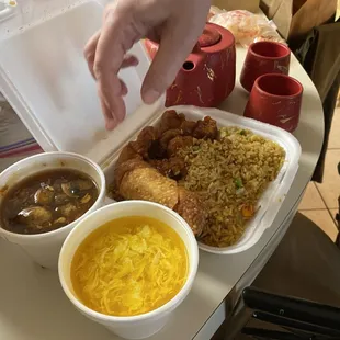 a person grabbing a container of food