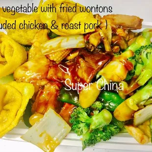 a plate of mixed vegetables with fried onions and chicken