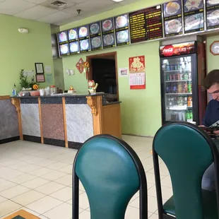 a woman sitting at a table in a restaurant