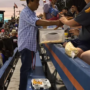 a crowd of people sitting in bleachers