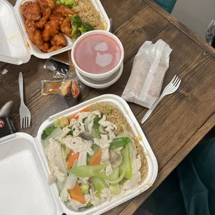 two take out containers of food on a table