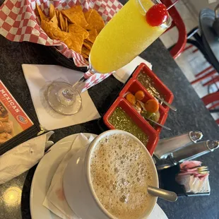 a cup of coffee and a plate of chips