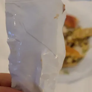 a hand holding a bag of food