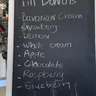 a blackboard with a list of donuts
