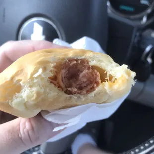 a person holding a donut in their hand