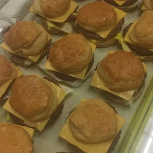 a tray of donuts with cheese on them
