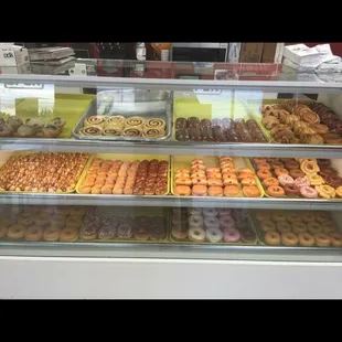 a variety of donuts in a display case