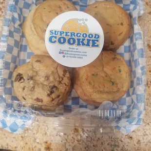 four cookies in a plastic container