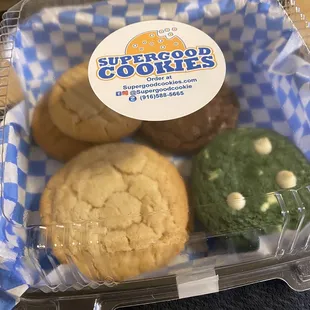 four cookies in a plastic container