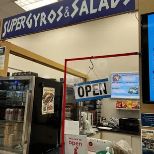 a super gyros and salads sign