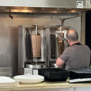 Slicing the meat off the spinning rotisserie