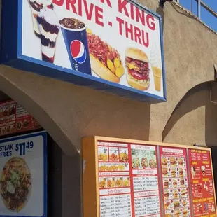 menus and prices on the side of the building