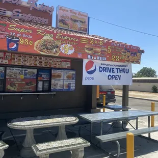 a drive thru restaurant with picnic tables