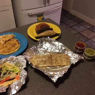 Takeout offerings: pupusa, tamale, torta (half), burrito and taco.