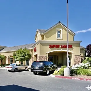 a parking lot with cars parked in front of the building