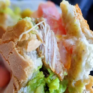 a person holding a sandwich