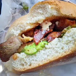 a hot dog with bacon and guacamole