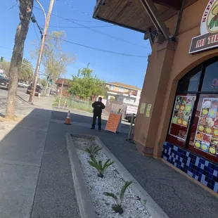 a man standing in front of a restaurant