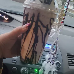 a hand holding a drink