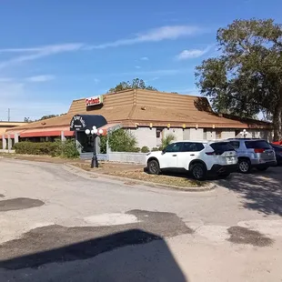 a parking lot with cars parked in front of it