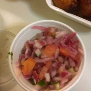 Side of tomato, onion salad.