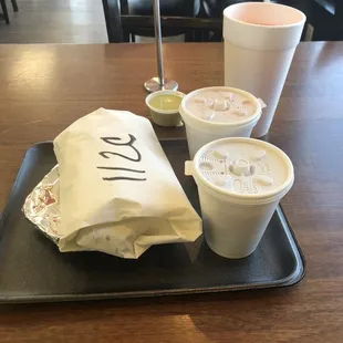 two cups of coffee and a bag of ice cream