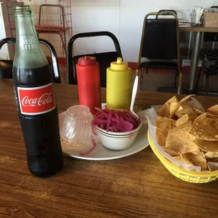 a coke and chips on a table