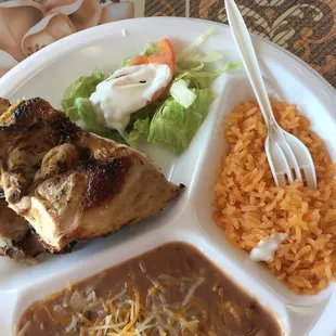 a plate of food with rice, meat, and beans
