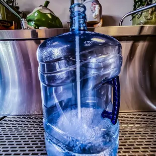 a water dispenser being filled with water