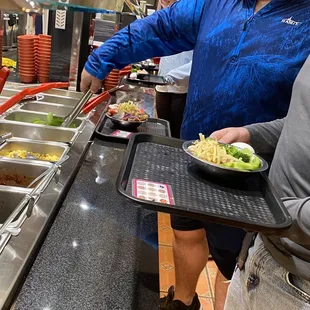 a man serving food to a woman