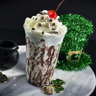 a chocolate milkshake with a cherry on top