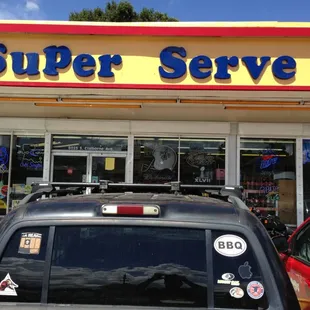 a car parked in front of a super serve store