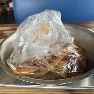 a bowl of food wrapped in plastic