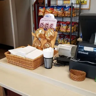 a counter with a basket of bread and a coffee maker