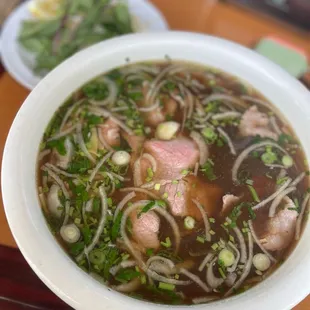 a bowl of soup with meat and noodles