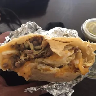 Breakfast burrito, egg,asada,hash brown,and cheese.yum