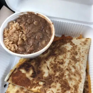 A side of rice and beans and a cheese quesadilla