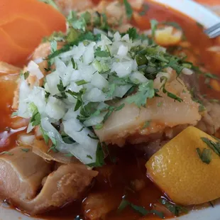 a bowl of soup with meat and vegetables