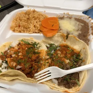 two tacos and rice in a styrofoam container