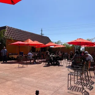 tables with red umbrellas