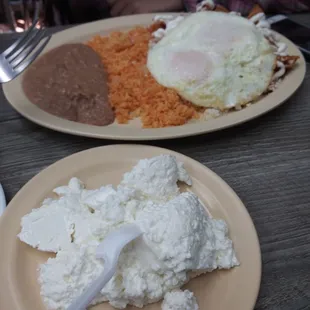 Chilaquiles con huevos with side of cheese.