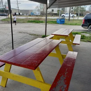 a red and yellow picnic table