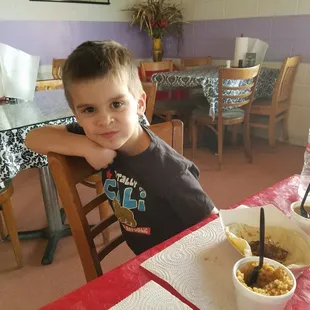 My son enjoying the molleja taco, beans and rice