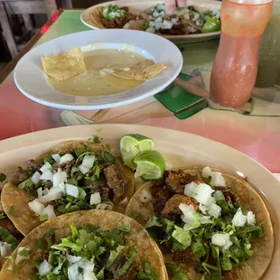a plate of tacos and a drink