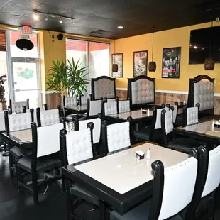 a dining area with tables and chairs