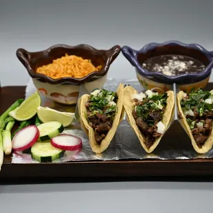 a variety of tacoss on a tray