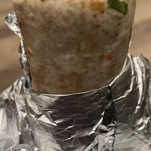 a burrito wrapped in aluminum foil