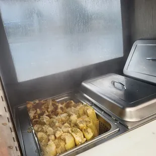 a pan of food being cooked in a grill