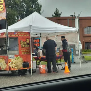 a man selling food from a food cart