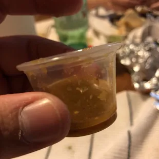 a person holding a small container of food